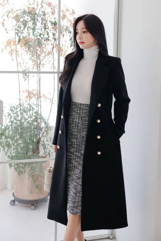 Elegant and warm this long black wool coat features a tailored fit classic lapels button front full lining and roomy pockets — perfect for winter style work or everyday wear.